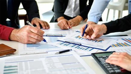 A group of homeowners discussing financial documen